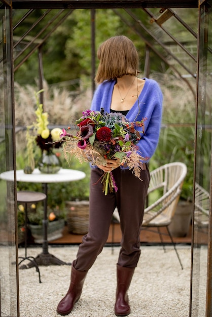 Frau mit Blumenstrauß im Garten