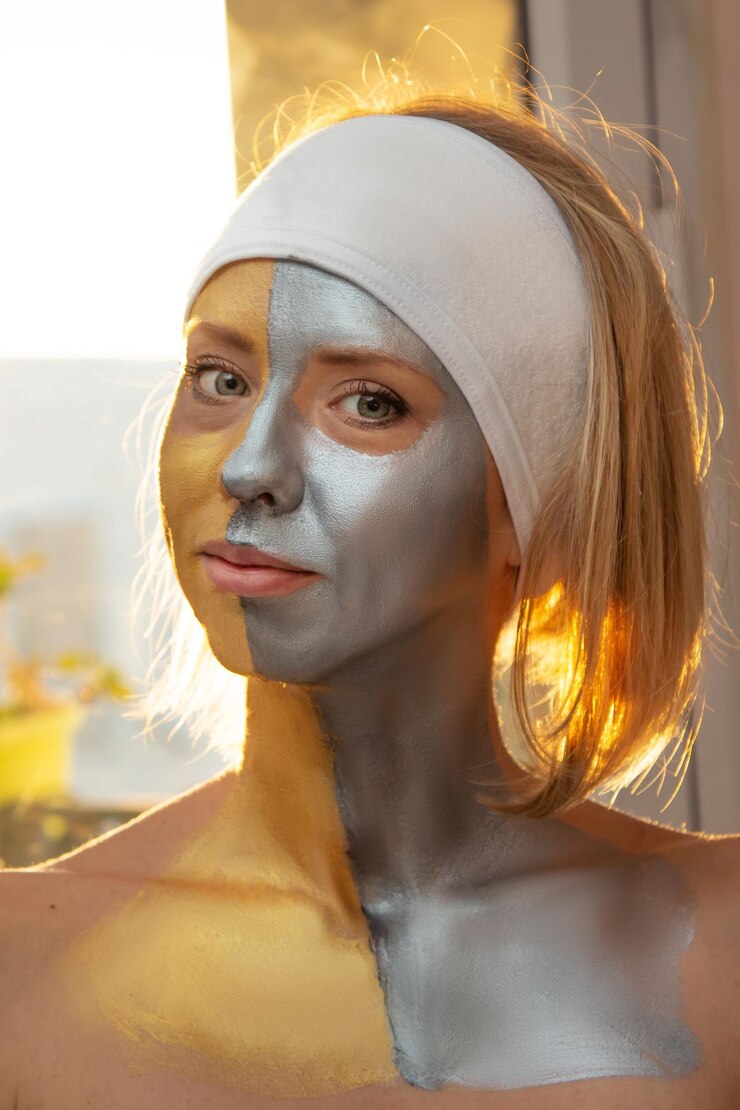 Foto frau mit einer goldenen oder silbernen maske auf dem gesicht in einem spa-salon