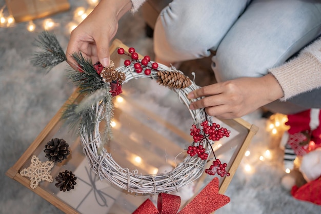 Frau mit Geschenk und Geschenk für Weihnachts- und Neujahrsparty zu Hause.