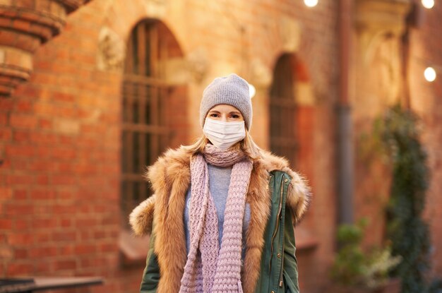 Frau mit Gesichtsmaske wegen Luftverschmutzung oder Virusepidemie in der Stadt