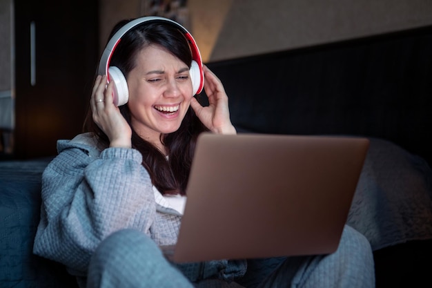 Frau mit Headset, die am Laptop arbeitet, hat Videoanruf-Fernjob von zu Hause aus