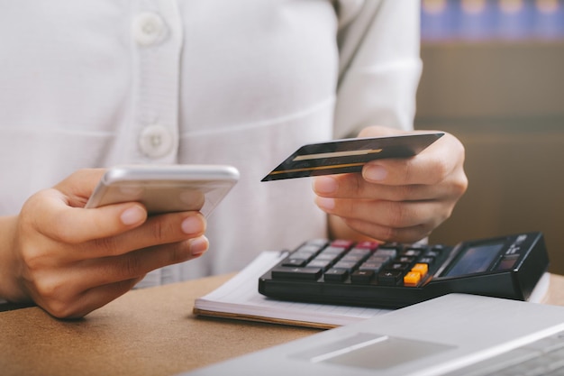 Frau mit Kreditkarte und Smartphone Online-Shopping Banking von zu Hause aus Konzept