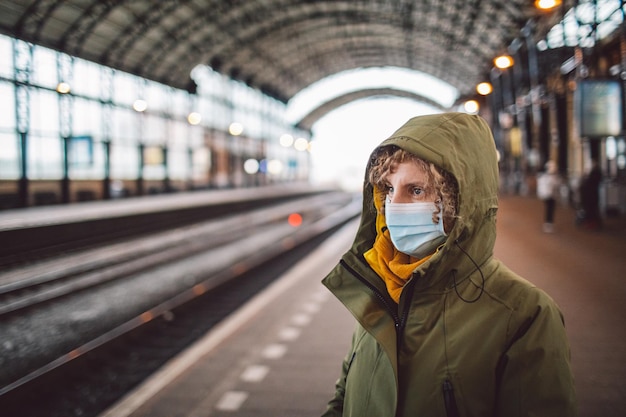 Frau mit Maske steht auf der Plattform