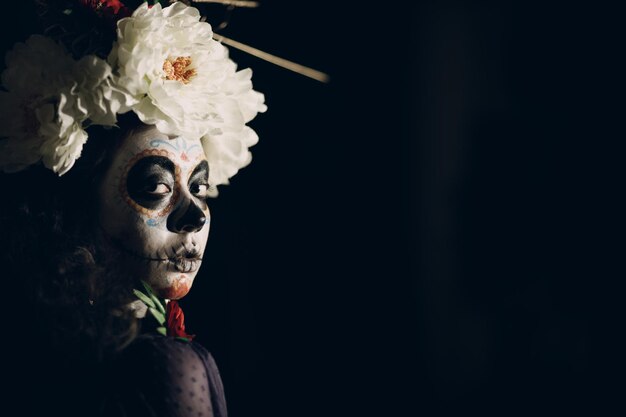 Frau mit mexikanischem Schädel Halloween Make-up auf ihrem Gesicht Tag der Toten und Halloween