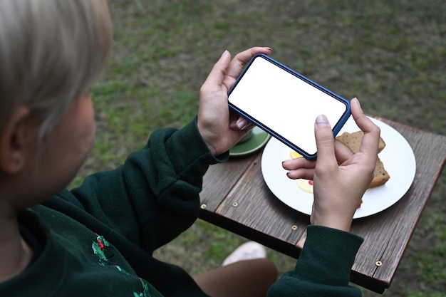 Frau mit Smartphone beim Fotografieren