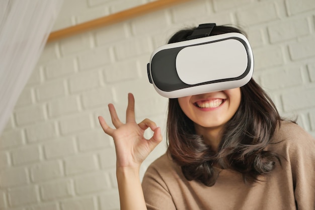 Frau mit VR-Headset, die eine gute Handgeste gibt