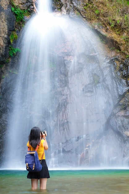 Frau Reisende nehmen Foto Wasserfall von ihrer Kamera