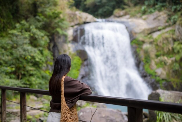 Frau, sieh dir den wunderschönen Wasserfall an.