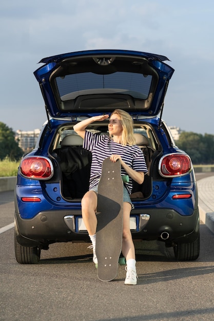 Foto frau sitzt hinten im auto und genießt den sonnenuntergang während der sommerferien, abenteuer, straßenreisen im fahrzeug