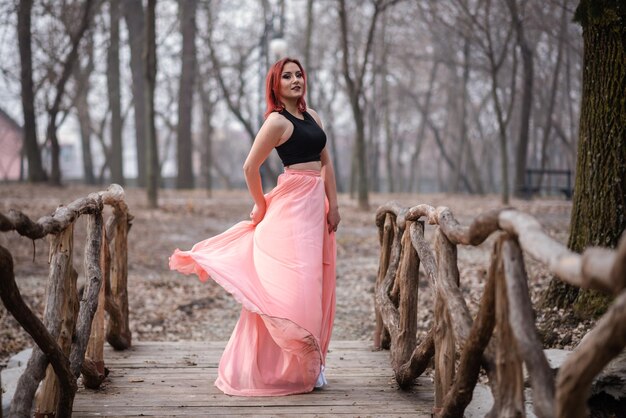 Foto frau steht am baum im wald