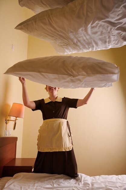 Foto frau wirft kissen im zimmer