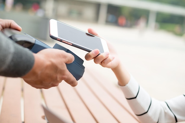 Frauen bezahlen am POS-Automaten per NFC-Technologie