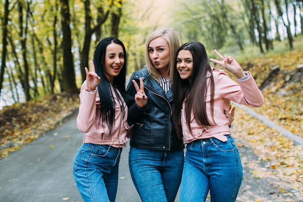 Foto frauen, die im herbstpark aufwerfen