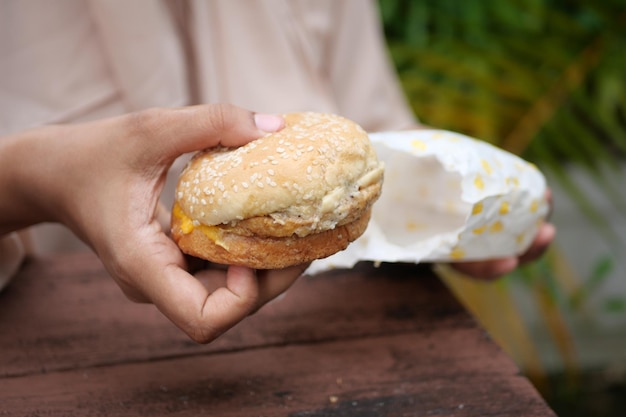 Frauen halten Draufsicht des Rindfleischburgers in der Hand