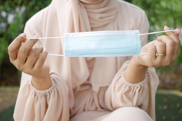 Frauen halten Gesichtsmaske in der Hand