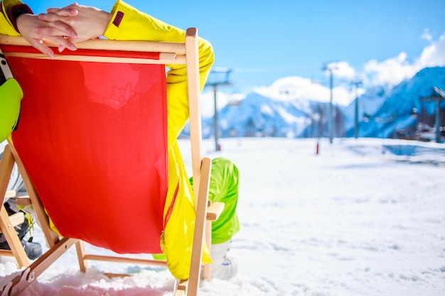 Frauen in den Bergen im Winter liegen auf der Sonnenliege