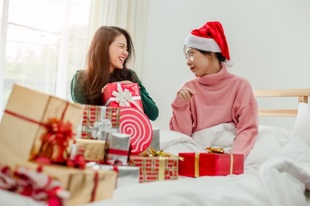 Frauen öffnen Geschenk auf dem Bett.