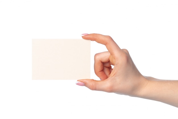 Frauenhand mit leerer weißer Visitenkarte lokalisiert auf Weiß