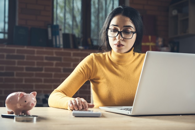 Frauenhandrechner mit Computer auf dem Tisch