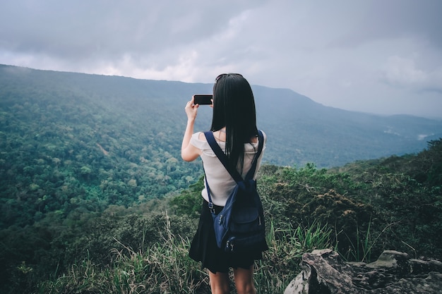 Frauenreisender, der Fotoansicht der Natur auf den Berg während der Ferien nimmt.