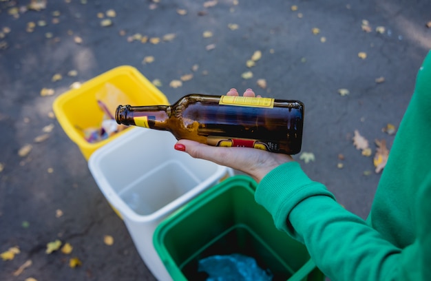 Freiwilliges Mädchen sortiert Müll in der Straße des Parks. Konzept des Recyclings