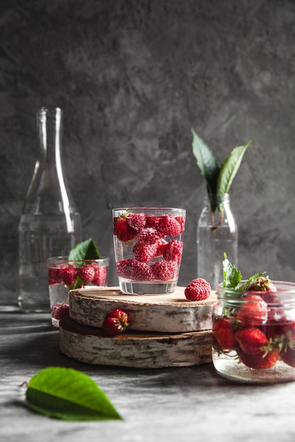 Fresas en agua sobre gris oscuro.