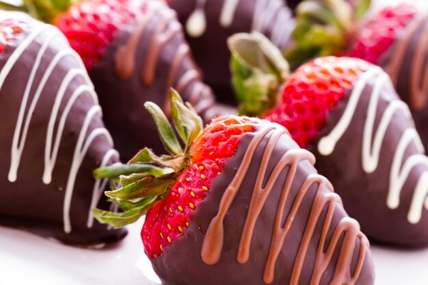 Fresas bañadas en chocolate en la barra de postres.