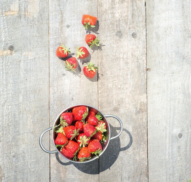 Fresas rojas maduras en el espacio de copia de la vista superior de la mesa de madera