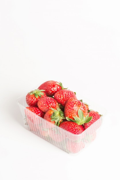 Fresas rojas naturales en una caja transparente de plástico