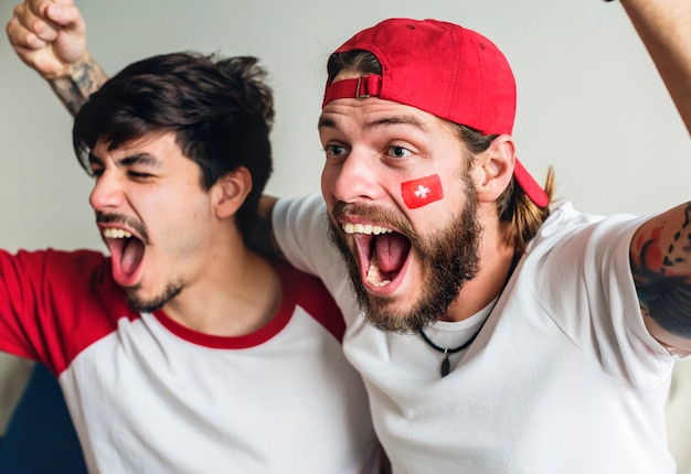 Freunde, die Weltmeisterschaft mit gemalter Flagge jubeln