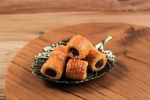 Frisch gebackene Ananas-Tart-Roll-Plätzchen (Tart Nanas oder Kuih Nenas) auf Holzuntergrund. Vor dem Verkauf bei Eid Mubarak