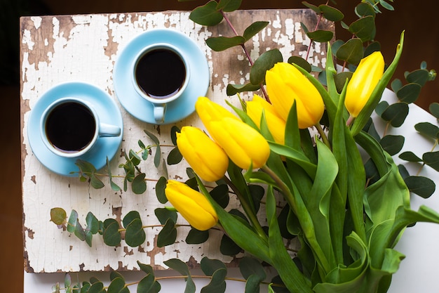 Frisch gebrühter Kaffee und gelbe Tulpen