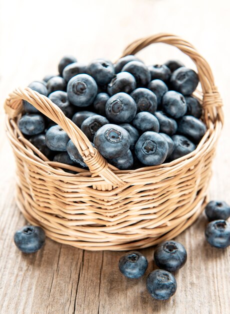 Frisch gepflückte blaubeeren auf einem alten hölzernen hintergrund. konzept für gesunde ernährung