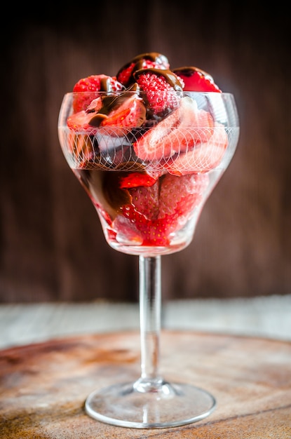 Frische Erdbeeren unter Schokoladenbelag im Glas