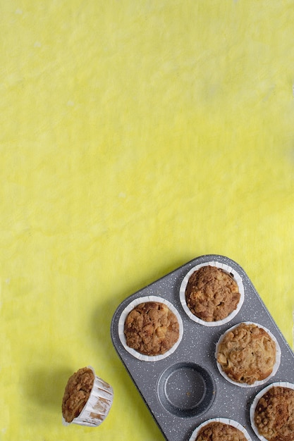 Frische gebackene Muffins auf hellem Gelb