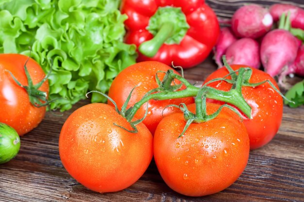 Frische organische rote Tomaten auf Gemüsehintergrund