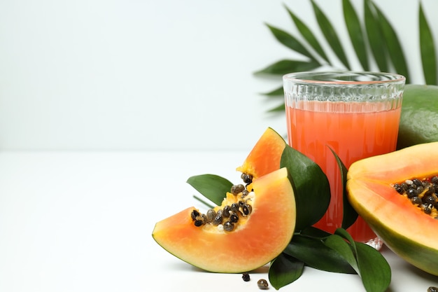 Frische Papaya und Saft auf weißem Tisch, Platz für Text