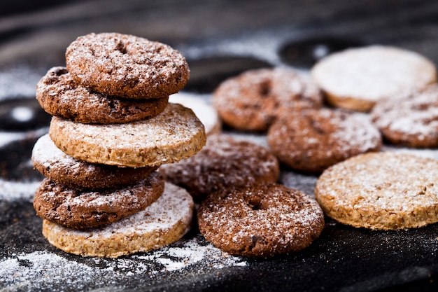 Frische Plätzchen des Schokoladensplitters und des Hafers mit Zuckerpulverstapel