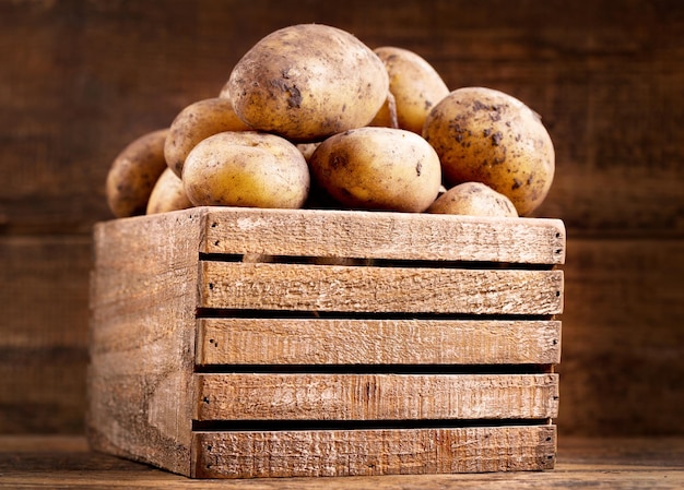 Frische rohe Kartoffeln in einer Holzkiste