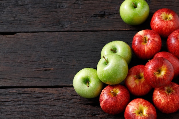 Frische rote und grüne Äpfel auf dem Holzboden