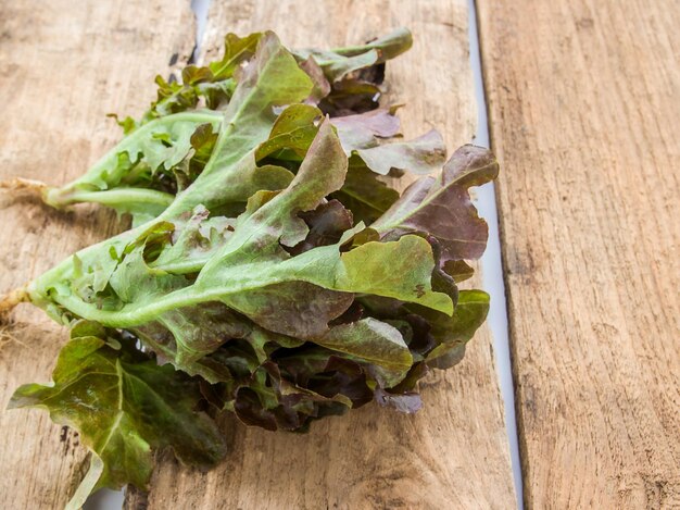 Frische Salatblätter auf einem hölzernen Hintergrund