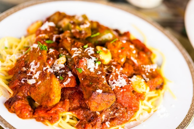 Frische Spaghetti mit Wurst, Paprika und Zwiebeln im italienischen Restaurant.