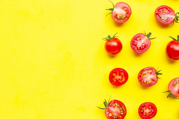 Frische Tomaten, ganzer und halber Schnitt lokalisiert auf Gelb