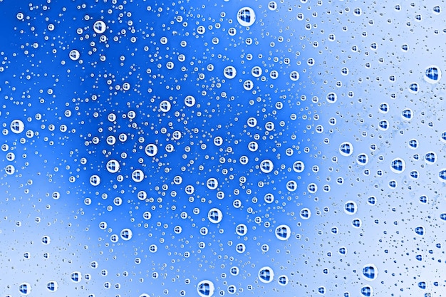 frische Tropfen Hintergrund blaues Glas / nasser regnerischer Hintergrund, Wassertropfen transparentes Glas blau