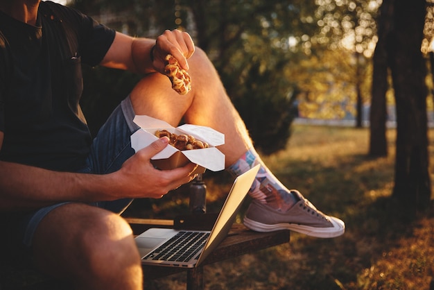 Frische Waffel, die in den Händen hält, amerikanisches Essen zum Mitnehmen. Filmkorn, getöntes Bild