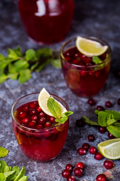 Frischer Cranberrysaft im Glas mit frischer Minze und Limette