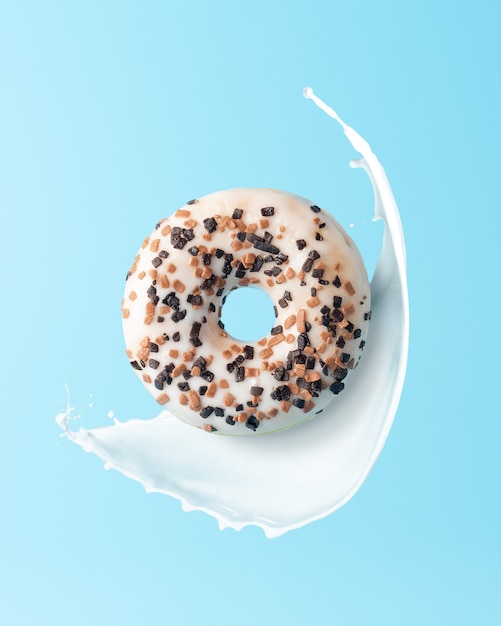 Frischer Donut mit Milch spritzt auf blauem Hintergrund