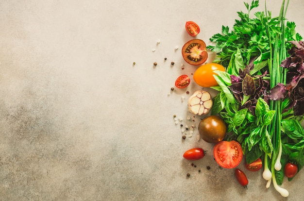 Frischer Spinat, Zwiebeln, Basilikum, Kräuter, Dill und Tomaten. Lebensmittel kochen Zutaten. Veganes, rohes, entgiftendes Konzept