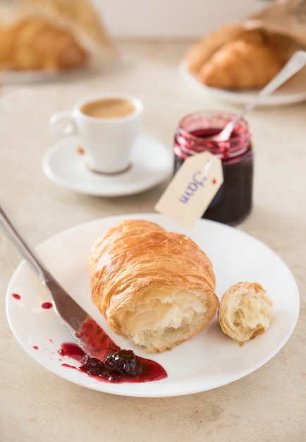 Frisches Frühstück am Morgen. Croissant mit Marmelade und Kaffee.