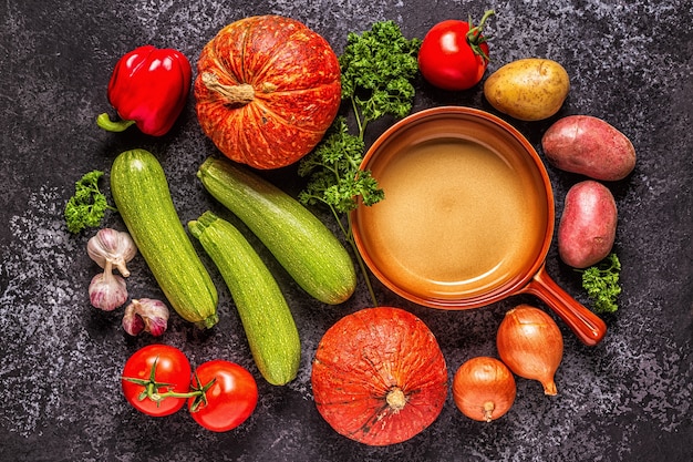 Frisches Herbstgemüse zum Kochen auf dunklem Hintergrund, Ansicht von oben.